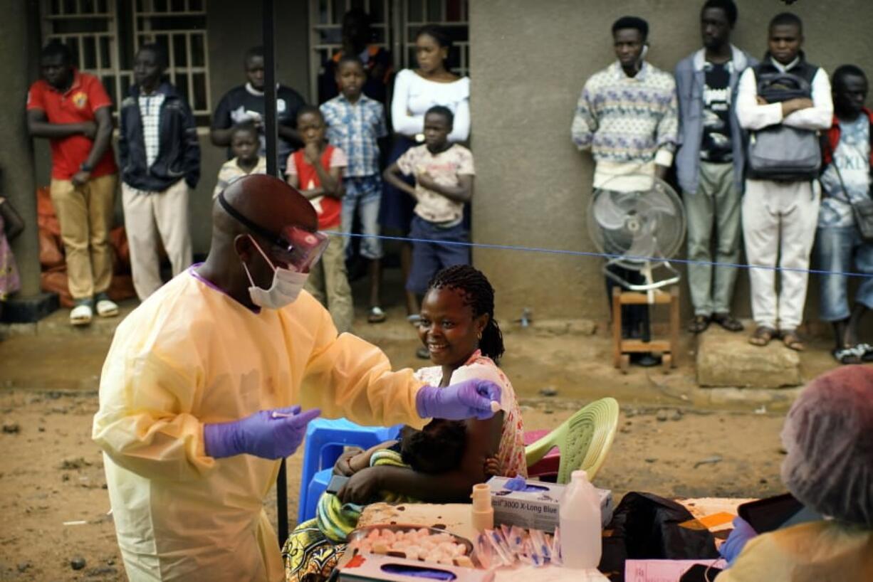 In this photo taken on Saturday, July 13, 2019, a nurse vaccinates a child against Ebola in Beni, Congo DRC. The World Health Organization has declared the Ebola outbreak an international emergency after spreading to eastern Congo’s biggest city, Goma, this week. More than 1,600 people in eastern Congo have died as the virus has spread in areas too dangerous for health teams to access.