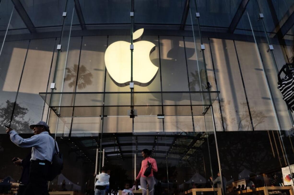 FILE - In this June 15, 2019, file photo customers leave an Apple store on the 3rd Street Promenade in Santa Monica, Calif. Apple Inc. reports financial results on Tuesday, July 30.