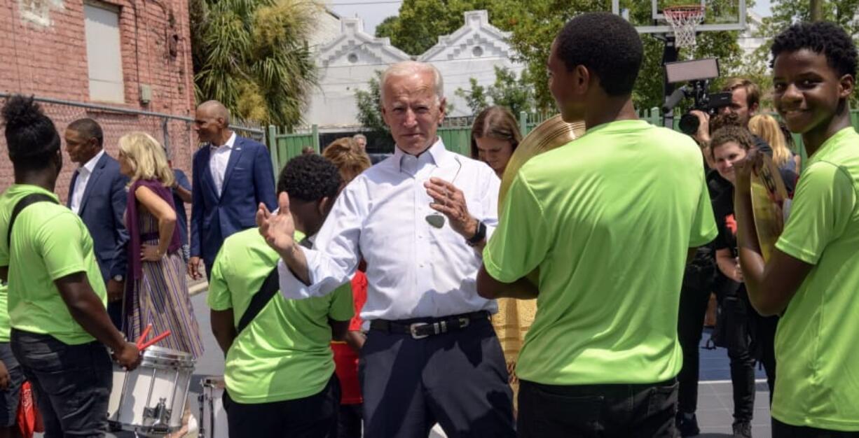 Democratic presidential candidate former Vice President Joe Biden speaks to kids as he tours the Youth Empowerment Project that targets at risk youth and young people with the drum line in New Orleans, Tuesday, July 23, 2019.