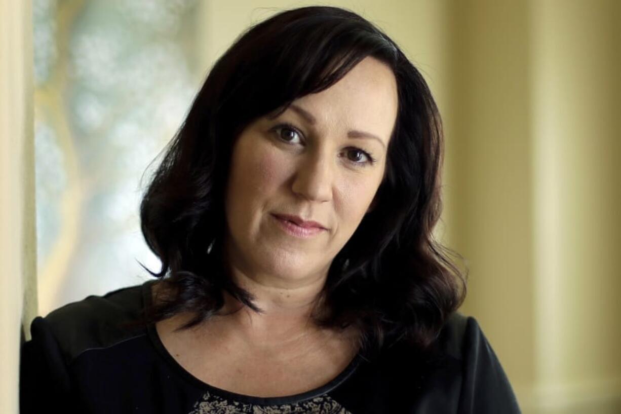 FILE - In this Aug. 9, 2018 file photo, MJ Hegar poses for a portrait at her home in Round Rock, Texas. Democratic candidates in some key states in the 2020 race aren’t going along as some in the party’s presidential field takes a hard liberal turn. In Texas, party leaders say they are confident in Air Force veteran Hegar taking on Republican incumbent John Cornyn but they also are not discouraging progressives from challenging her.