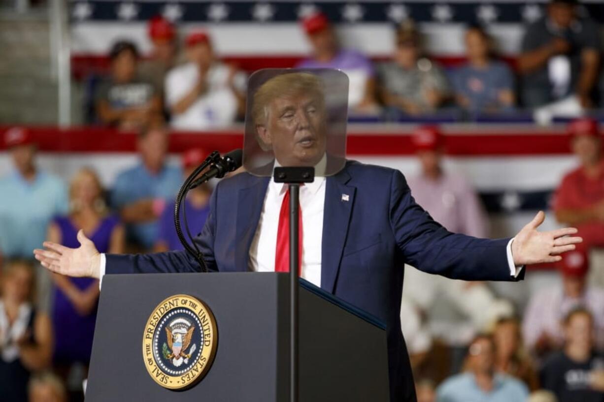 President Donald Trump is seen though a teleprompter as he speaks at a campaign rally at Williams Arena in Greenville, N.C., Wednesday, July 17, 2019.