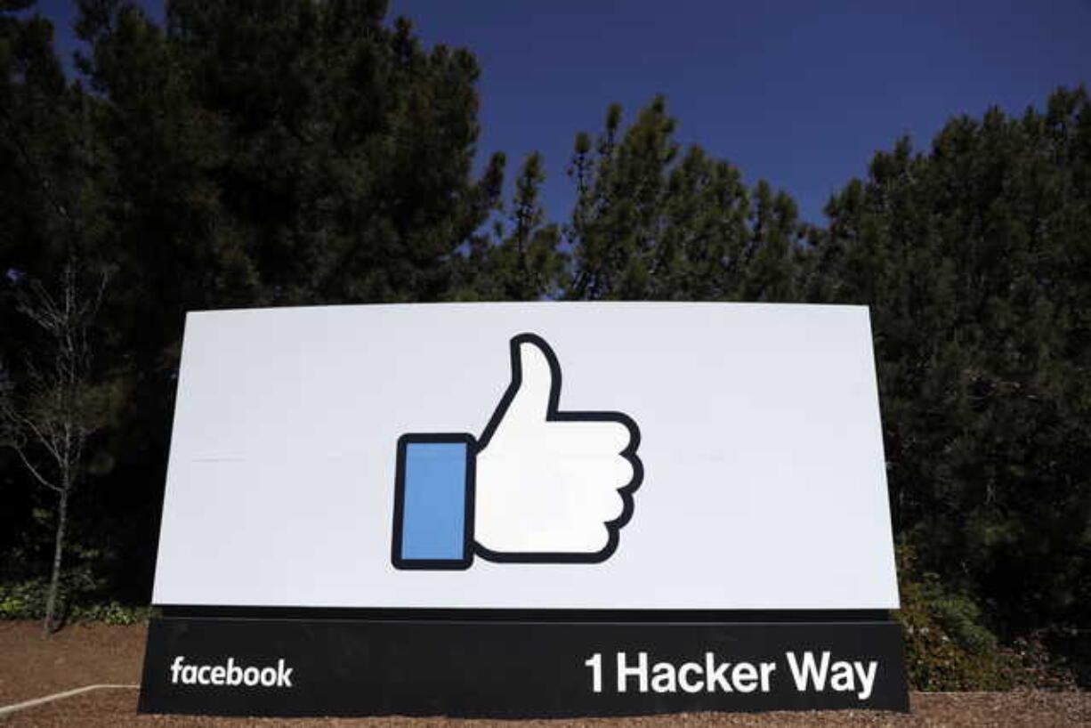 This March 28, 2018, file photo shows a Facebook logo at the company's headquarters in Menlo Park, Calif. Facebook’s ambitious plan to create a new financial system based on a digital currency faces questions from lawmakers, as it’s shadowed by negative comments from President Donald Trump, his Treasury secretary and the head of the Federal Reserve.