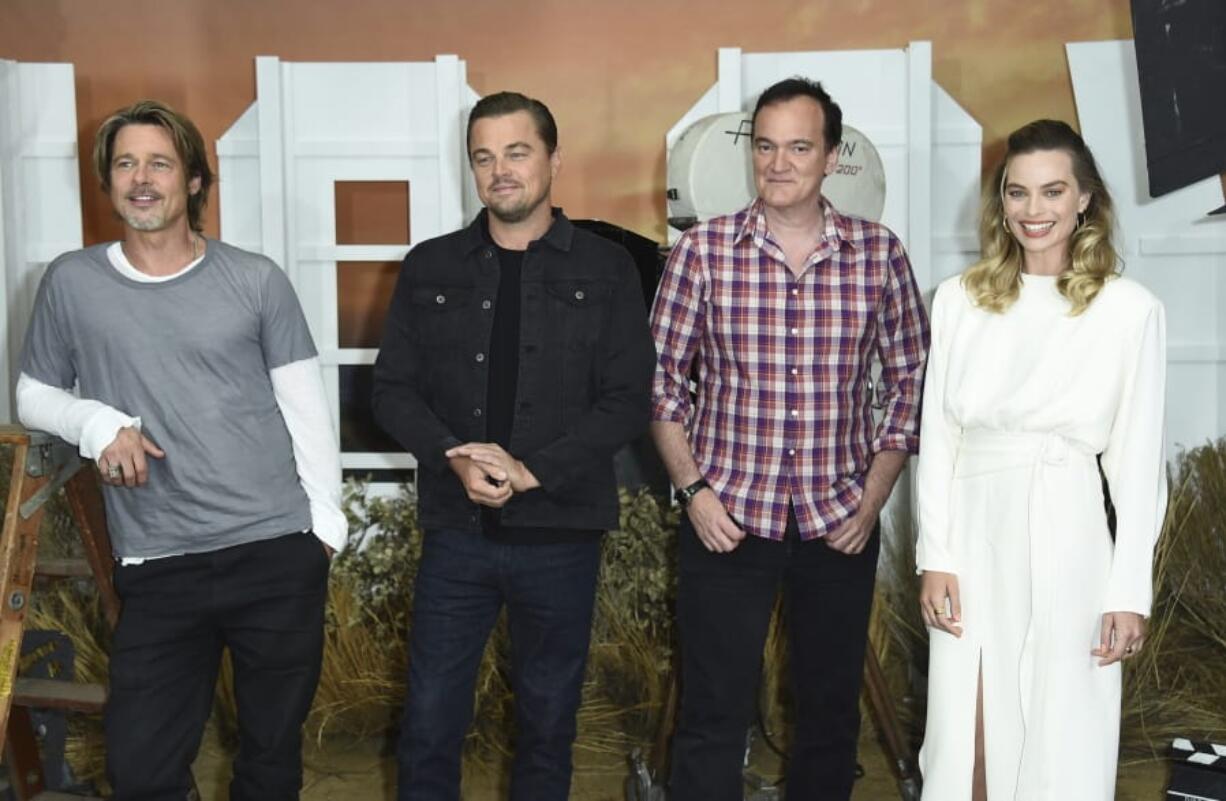 Brad Pitt, from left, Leonardo DiCaprio, Quentin Tarantino and Margot Robbie attend the photo call for “Once Upon a Time … in Hollywood” on July 11 at the Four Seasons Hotel in Los Angeles. The film opens July 26.