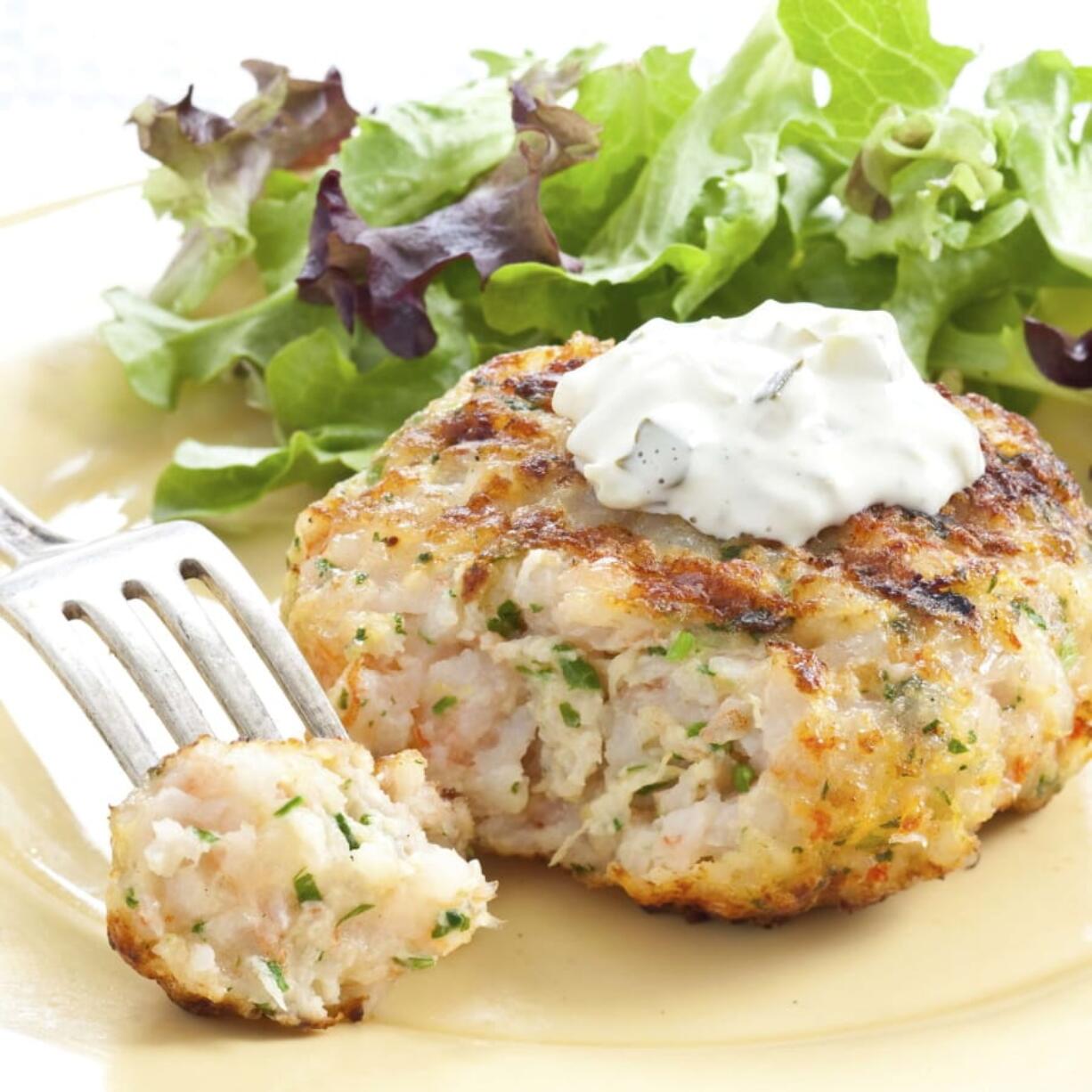 This undated photo provided by America’s Test Kitchen in July 2019 shows Grilled Southern Shrimp Burgers in Brookline, Mass. This recipe appears in the cookbook “Master of the Grill.” (Daniel J.