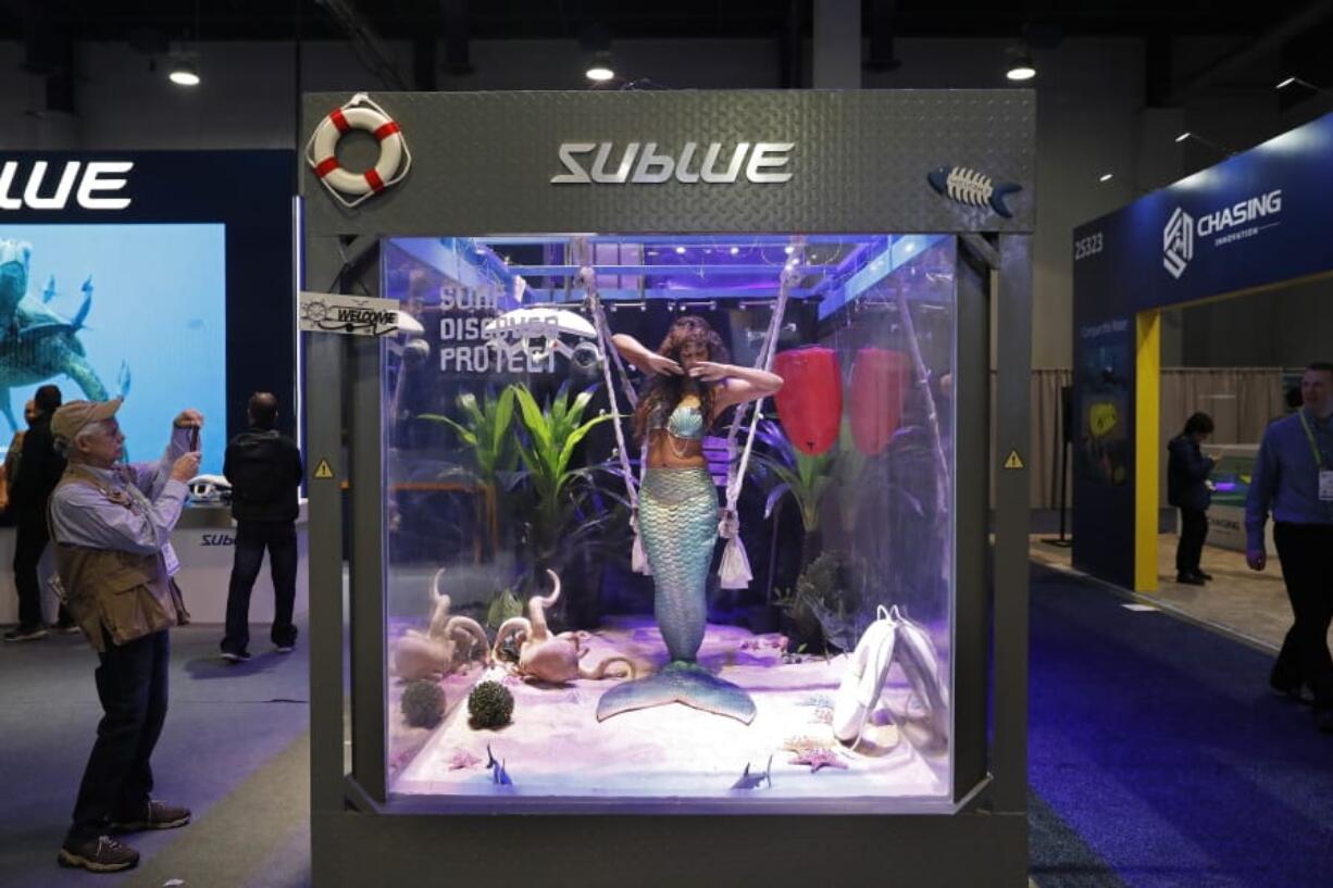 A woman dressed as a mermaid performs at the Sublue booth in January at CES International in Las Vegas. The group that organizes the annual CES gadget show is cracking down on its dress code, introducing more programming focused on women and minorities and creating a new “sex tech” category. The moves are aimed at addressing complaints that the 52-year-old electronics show is too male-dominated.