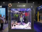 A woman dressed as a mermaid performs at the Sublue booth in January at CES International in Las Vegas. The group that organizes the annual CES gadget show is cracking down on its dress code, introducing more programming focused on women and minorities and creating a new “sex tech” category. The moves are aimed at addressing complaints that the 52-year-old electronics show is too male-dominated.