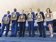 National Baseball Hall of Fame inductees Harold Baines, Lee Smith, Edgar Martinez, Mike Mussina, Mariano Rivera , and Brandy Halladay window of the late Roy Halladay hold their plaques for photos after the induction ceremony at Clark Sports Center on Sunday, July 21, 2019, in Cooperstown, N.Y.