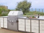 Kalamazoo Outdoor Gourmet’s Hybrid professional grill and Arcadia series cabinetry is shown at a home in Grand Beach, Mich. Adding built-in cooking and storage space around a grill increases the value of a home.