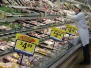 A worker stocks the fresh meat shelves March 1, 2011 at a Kroger Co. supermarket in Cincinnati. The supermarket is one of the most important places to be shopping-savvy. The good news is that there are so many easy and effective way to slash your grocery budget.