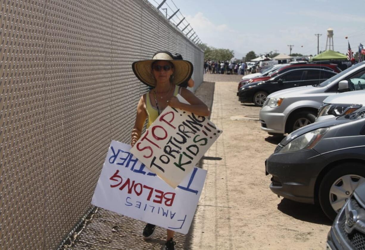 A grandmother protesting the treatment of children in Border Patrol custody walks back to her car July 1 by a fence at a holding center in Clint, Texas. Yvonne Nieves, in her 50s, says she has a 2-year-old granddaughter. “I just couldn’t bear the fact that there would actually be little kids out here not knowing where their parents are, not having anyone to take care of them,” she said.