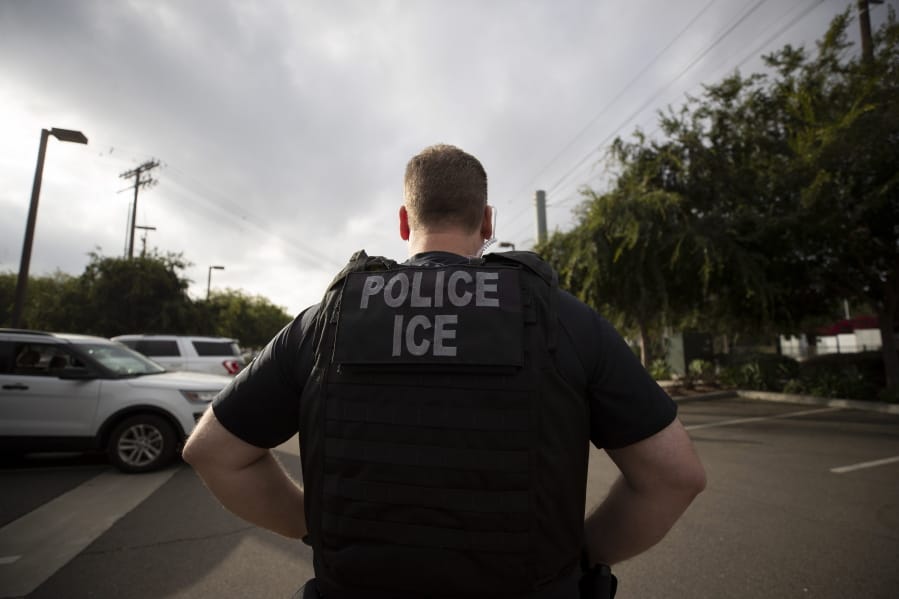 A U.S. Immigration and Customs Enforcement officer looks on during an operation July 8 in Escondido, Calif.