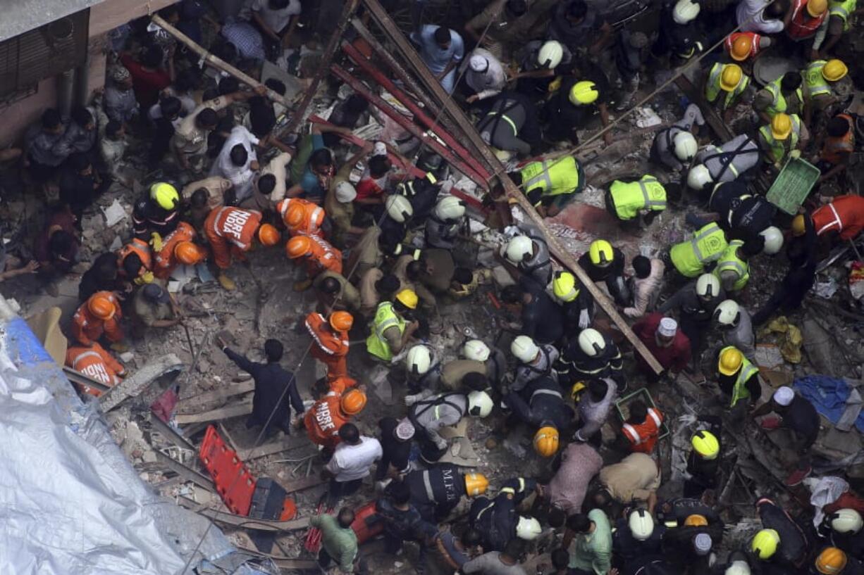 Rescuers work at the site of a building collapse Tuesday in Mumbai, India.