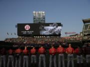 Members of the Los Angeles Angels observe a moment of silence for teammate Tyler Skaggs, before a baseball game against the Seattle Mariners on Friday, July 12, 2019, in Anaheim, Calif.