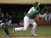 Oakland Athletics’ Matt Chapman watches his two-run home run off Seattle Mariners’ Marco Gonzales during the fifth inning of a baseball game Tuesday, July 16, 2019, in Oakland, Calif.