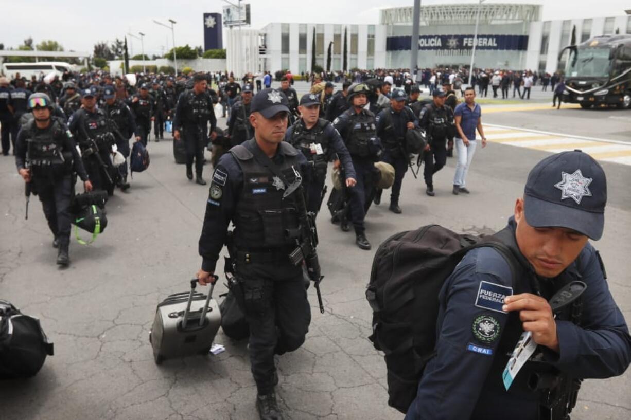 Uniformed Mexican federal police arrive to a police command center in the Iztapalapa borough of Mexico City, Wednesday, July 3, 2019, to protest plans to force federal police into the newly formed National Guard. Hundreds of Mexican federal police are in open revolt Wednesday against plans to absorb them into the newly formed National Guard, saying their seniority, rank and benefits are not being recognized within the National Guard.