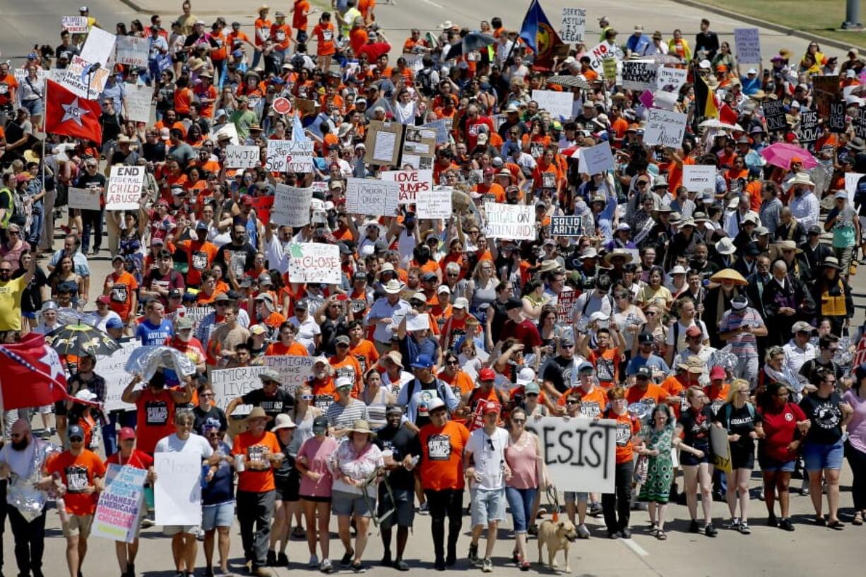 FILE - In this July 20, 2019 file photo, protestors march outside Fort Sill in protest of plans to place migrant children at the Army post in Lawton, Okla.