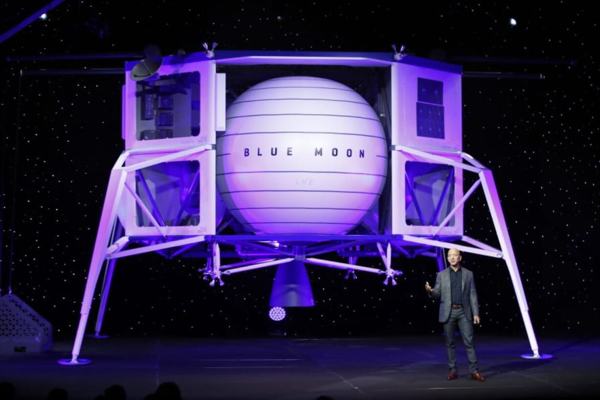 FILE - In this, May 9, 2019, file photo, Jeff Bezos speaks in front of a model of Blue Origin's Blue Moon lunar lander in Washington. Bezos and Virgin Galactic's Richard Branson favor going back to the moon before Mars. SpaceX's Elon Musk also is rooting for the moon, although his heart's on Mars.