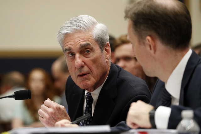 Former special counsel Robert Mueller, accompanied by his top aide in the investigation Aaron Zebley, right, testifies before the House Intelligence Committee hearing on his report on Russian election interference, on Capitol Hill, Wednesday, July 24, 2019 in Washington.