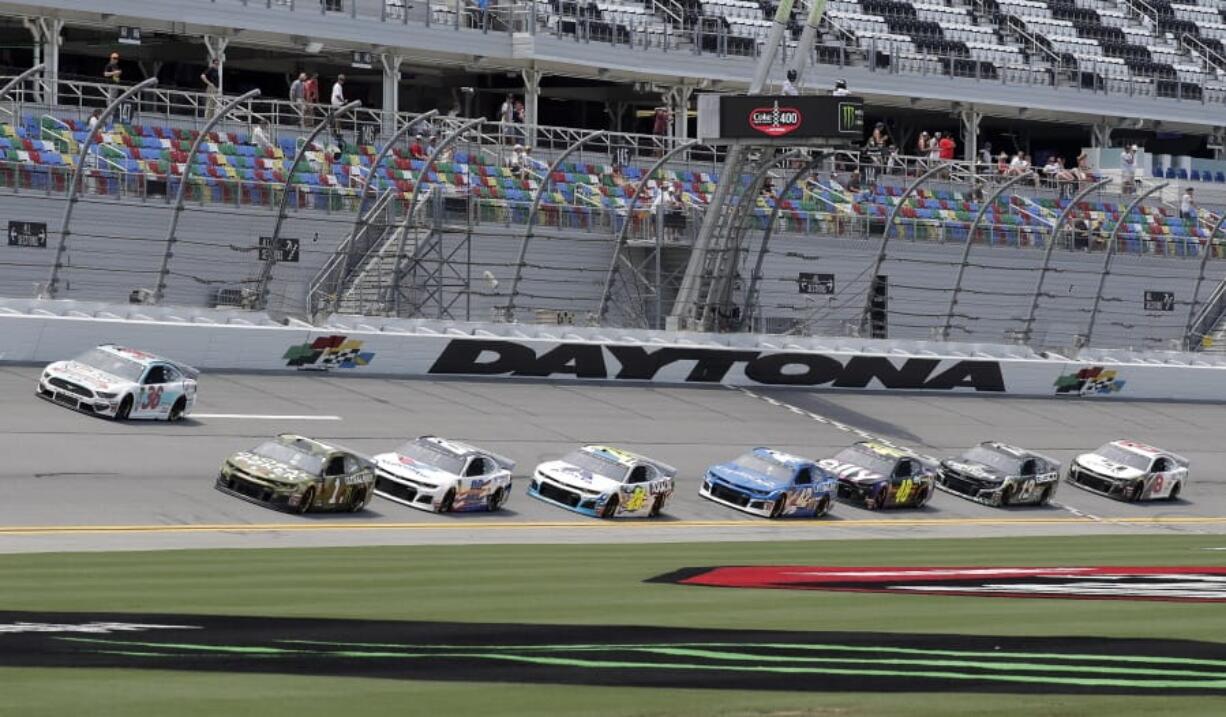 Matt Tifft (36), Kurt Busch (1) and Alex Bowman (88) lead a pack though the front stretch during a NASCAR auto race practice at Daytona International Speedway, Thursday, July 4, 2019, in Daytona Beach, Fla.