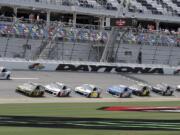 Matt Tifft (36), Kurt Busch (1) and Alex Bowman (88) lead a pack though the front stretch during a NASCAR auto race practice at Daytona International Speedway, Thursday, July 4, 2019, in Daytona Beach, Fla.