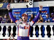 Denny Hamlin celebrates in Victory Lane after winning a NASCAR Cup Series auto race, Sunday, July 28, 2019, in Long Pond, Pa.