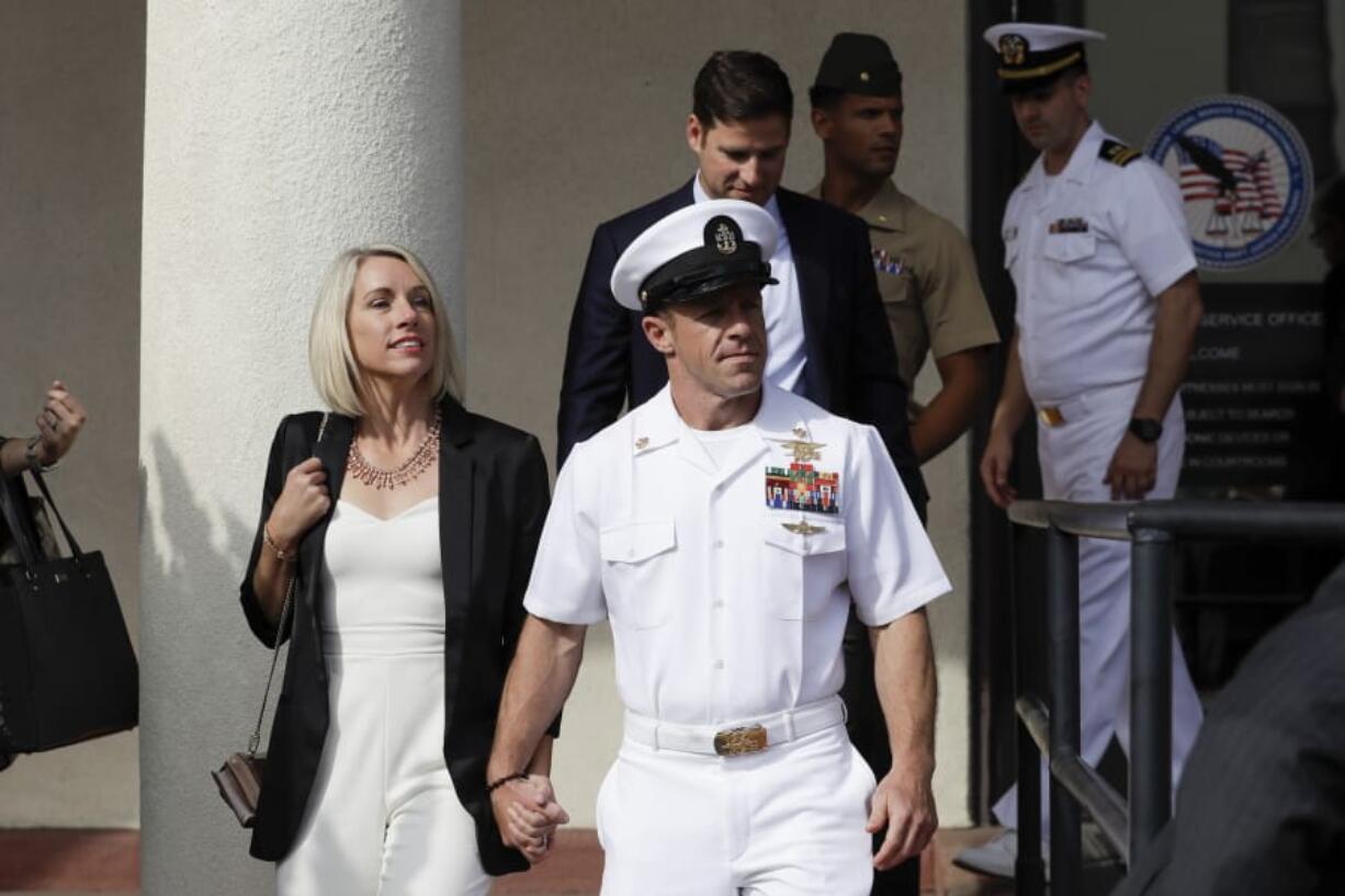 Navy Special Operations Chief Edward Gallagher, center, walks with his wife, Andrea Gallagher, as they leave a military court on Naval Base San Diego, Tuesday, July 2, 2019, in San Diego. A military jury acquitted the decorated Navy SEAL Tuesday of murder in the killing of a wounded Islamic State captive under his care in Iraq in 2017.