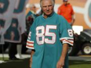 FILE - In this Dec. 16, 2012, file photo, Nick Buoniconti, former Miami Dolphins player and member of the 1972 undefeated team, in introduced during the half time show of an NFL football game against the Jacksonville Jaguars, in Miami. Pro Football Hall of Fame middle linebacker Nick Buoniconti, an undersized overachiever who helped lead the Miami Dolphins to the NFL’s only perfect season, has died at the age of 78. Bruce Bobbins, a spokesman for the Buoniconti family, said he died Tuesday, July 30, 2019, in Bridgehampton, N.Y.