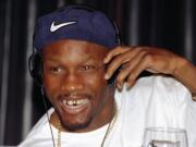 FILE - In this April 9, 1997, file photo, WBC welterweight champion Pernell Whitaker adjusts his head phones during a news conference in Las Vegas. Former boxing champion Pernell Whitaker has died after he was hit by a car in Virginia. He was 55. Police in Virginia Beach on Monday say Whitaker was a pedestrian when struck by the car Sunday night, July 14, 2019. The driver remained on the scene, where Whitaker was pronounced dead.