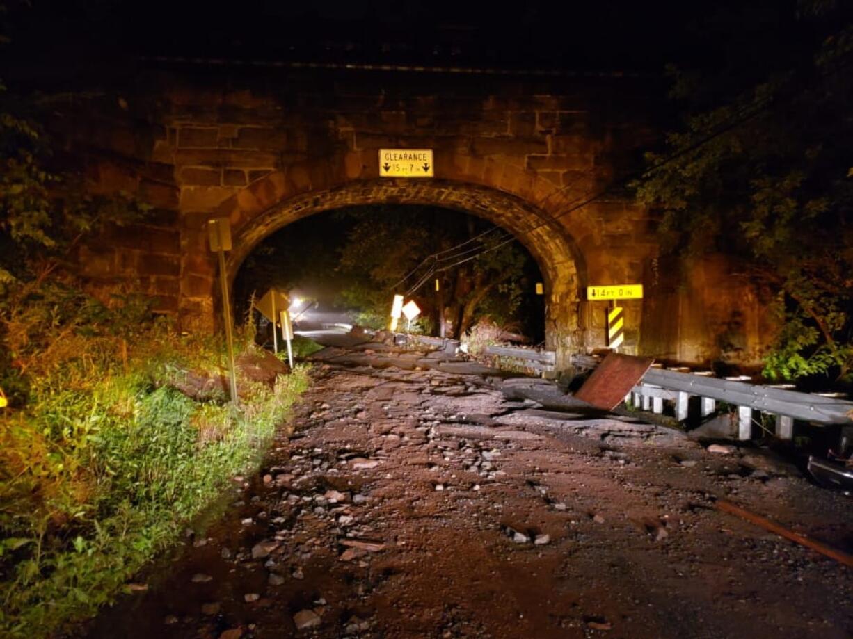 Flooding claimed the lives of a pregnant woman and her 8-year-old son whose car was swept away near the Colebrook Railroad trestle crossing Thursday, July 11, 2019 in Boyertown, Pa. Douglass Township Police Chief John says the car was swept down the Manatawny Creek for about a half-mile on Thursday night, while the woman was on the phone with emergency officials. The call then dropped, and emergency workers found the car in a tributary nearly five hours later. The names of the woman and child have not been released.