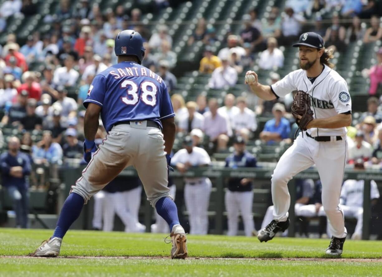 Seattle Mariners starting pitcher Mike Leake, right, runs down Texas Rangers’ Danny Santana (38) on a fielder’s choice hit by Rangers’ Elvis Andrus during the first inning of a baseball game, Wednesday, July 24, 2019, in Seattle. (AP Photo/Ted S.