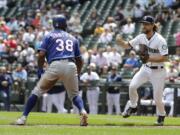 Seattle Mariners starting pitcher Mike Leake, right, runs down Texas Rangers’ Danny Santana (38) on a fielder’s choice hit by Rangers’ Elvis Andrus during the first inning of a baseball game, Wednesday, July 24, 2019, in Seattle. (AP Photo/Ted S.