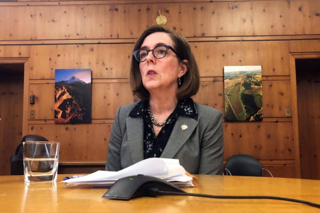 FILE - In this Monday, July 1, 2019, file photo, Oregon Gov. Kate Brown speaks with the media at the Capitol in Salem, Ore. Republicans concerned about losing their grip on political power in the states have added a new tool to their playbook, the recall election. Once reserved for recalling corrupt, absent or inept elected officials, the recall process has been turned into a political weapon by Republicans seeking to undo the results of regular elections.