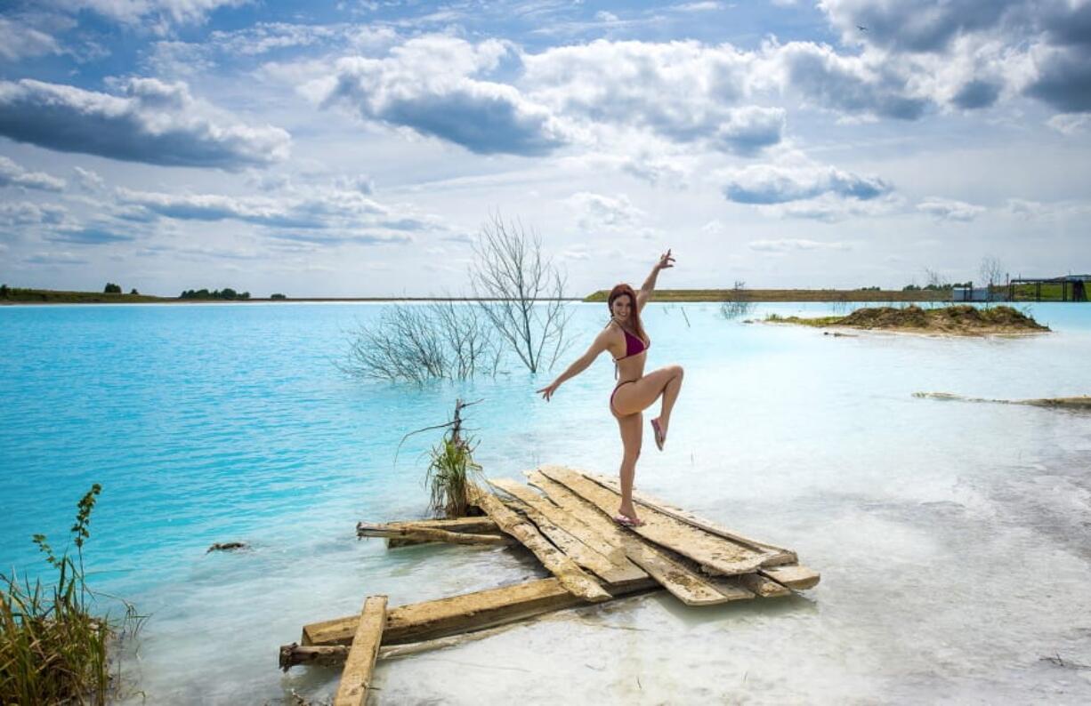 In this undated handout photo taken by mrwed54, a woman poses for a photo by a lake in the Siberian city of Novosibirsk, about 2,800 kilometers (1,750 miles) east of Moscow, Russia. Thousands of Novosibirsk residents, from scantily clad women to newlyweds have been instagramming selfies near the lake nicknamed the “Siberian Malvides” after the far-flung tropical islands in the Indian Ocean. This is in fact is a man-made dumb of coal from a nearby power station that provides for most of Novosibirsk’s energy needs.