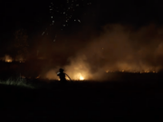 A firefighter from Fire District 6 puts out a field fire under the fireworks display at the Clark County Event Center at the Fairgrounds. The fire wasn't unexpected and the fire department was already on hand but the fire marshal ended the fireworks show early to 'err on the side of safety.' No one was injured and no buildings were damaged.