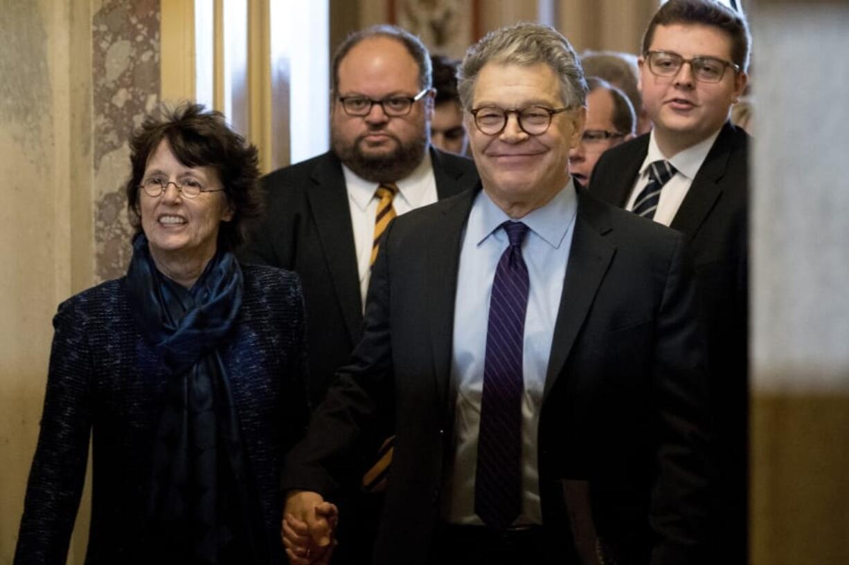 Sen. Al Franken, D-Minn., second from right, holds hands with his wife, Franni Bryson, left, Dec. 7, 2017, as he leaves the Capitol after speaking on the Senate floor on Capitol Hill in Washington. Franken says he “absolutely” regrets resigning from the Senate after eight women accused him of unwanted kissing or touching. Franken made the comments in an article published by the New Yorker magazine on Monday.