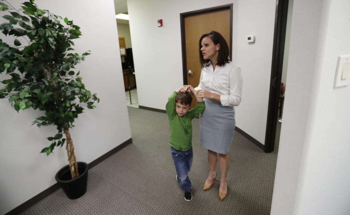 Bethany Babcock, co-owner of Foresite Commercial Real Estate, right, stands with her son, Ethan, at her office in San Antonio, Tuesday, July 23, 2019.