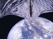 This photo provided on Thursday, July 25, 2019, by the Planetary Society shows a portion of the LightSail2 spacecraft, top, and part of Earth, centered on Baja California, Mexico. It was one of the photos transmitted from The Planetary Society’s LightSail 2 spacecraft, confirming the successful deployment of its solar sail.