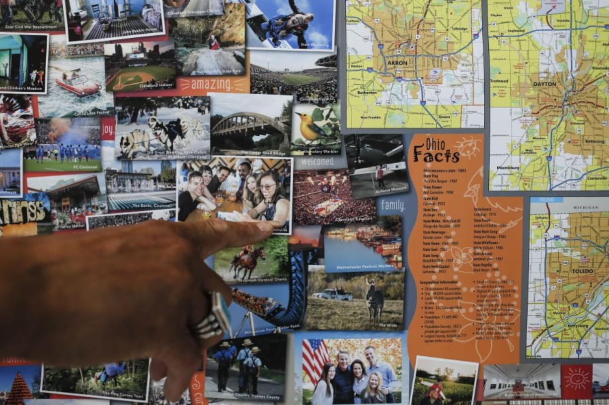 In this June 6, 2019, photo, Bruce Hull points to an image of his daughter on a state map as he is interviewed at his offices at the Ohio Department of Transportation in Columbus. If your summer travel plans involve traversing Ohio and you’re still a fan of paper maps, it’s time you meet Bruce Hull. As a layout design artist with the Ohio Department of Transportation since 1989, the 60-year-old Hull has creative control over the map’s look and feel, from the graphics to the paper to the fold that’s used.