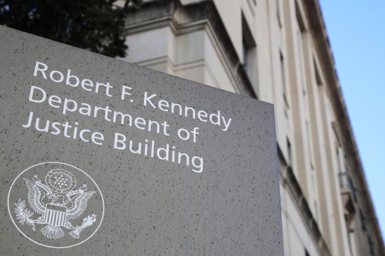 FILE - This Friday, March 22, 2019, file photo shows the Department of Justice Building in Washington. The U.S. Department of Justice is opening a sweeping antitrust investigation of major technology companies and whether their online platforms have hurt competition, suppressed innovation or otherwise harmed consumers.