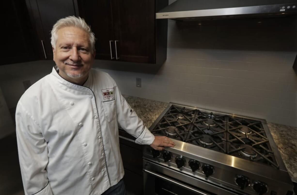 In this July 18, 2019, photo private chef Ken McNamee poses for a photo in Seattle. McNamee has cooked in exclusive clubs around the world, yet he’s sometimes overwhelmed by the scale of wealth around Seattle. (AP Photo/Ted S.