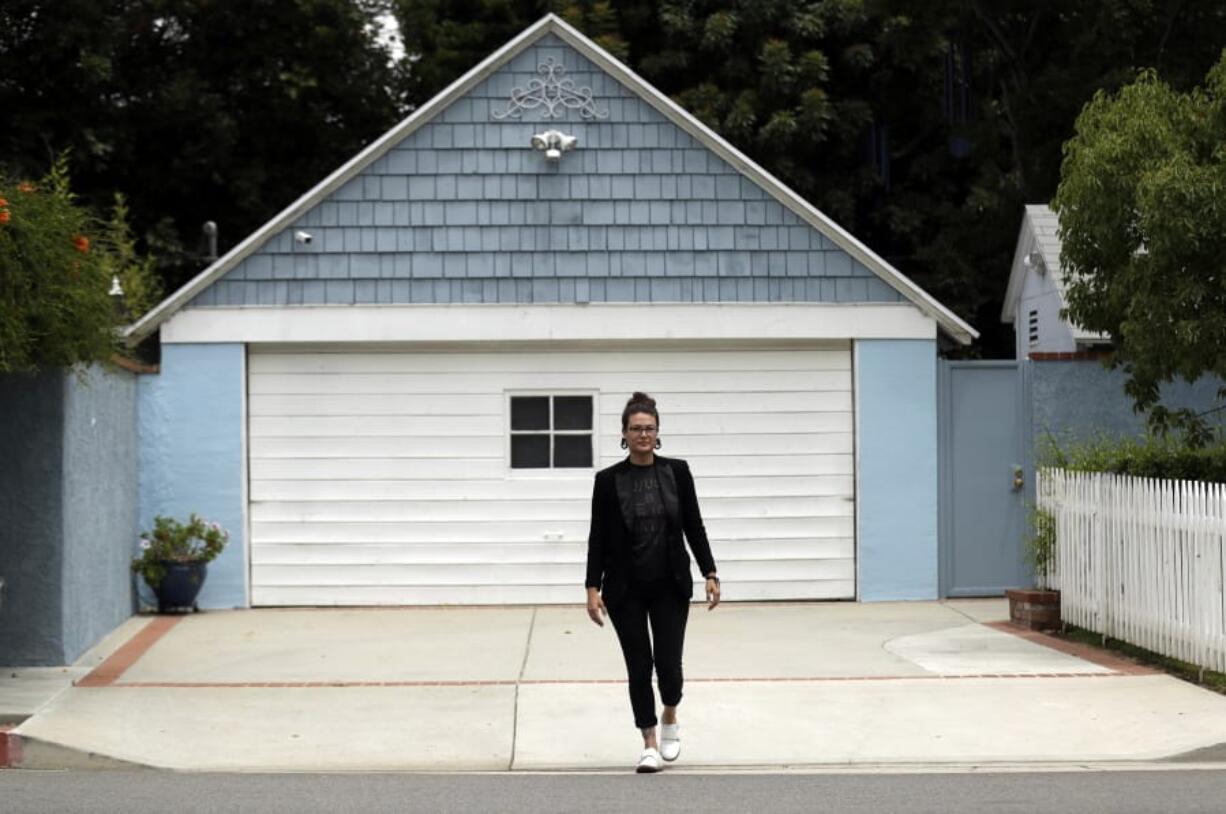 In this Wednesday, June 26, 2019, photo Hannah Moore poses for a portrait in Los Angeles. Moore has struggled to save since graduating from college in December 2007, the same month the Great Recession officially began. She has worked nearly continuously since then despite a couple of layoffs.