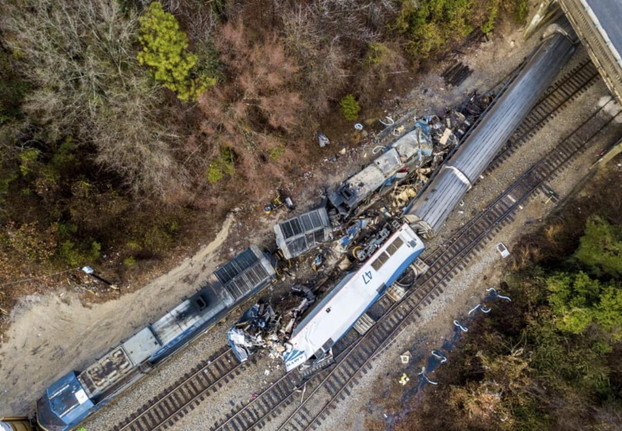 FILE- This Feb. 4, 2018, file photo shows an aerial view of the site of a fatal train crash between an Amtrak train, bottom right, and a CSX freight train, top left, in Cayce, S.C. Federal officials are meeting to discuss what caused an Amtrak train to divert on to a side track in South Carolina last year and slam into a parked train, killing two crew members and injuring more than 100 passengers. The National Transportation Safety Board is meeting Tuesday, July 23, 2019 in Washington, D.C.