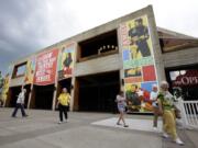 FILE - In this May 1, 2013, file photo, people visit the the Grand Ole Opry House in Nashville, Tenn. A new immersive film showing at the Circle Room explains the history of the Grand Ole Opry while showing video clips of over 100 different artists on stage. The 14-minute film is hosted by Garth Brooks and Trisha Yearwood.