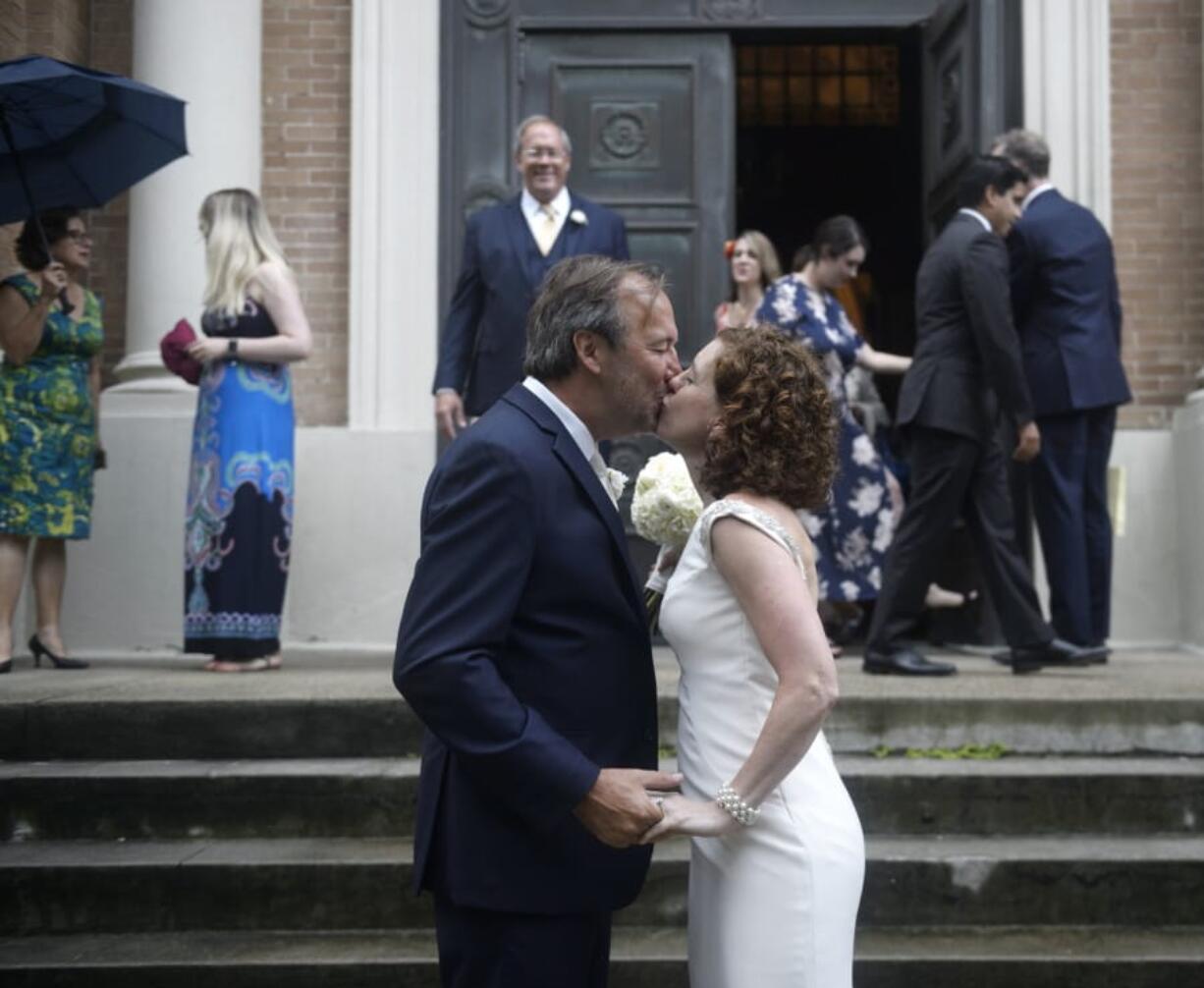 Associated Press staff photographer Gerald Herbert and Lucy Sikes kiss after being wed at Mater Dolorosa Catholic Church ahead of Tropical Storm Barry in New Orleans, Friday, July 12, 2019. Originally scheduled for Saturday, the couple moved the nuptials up a day to avoid the arrival of Barry.