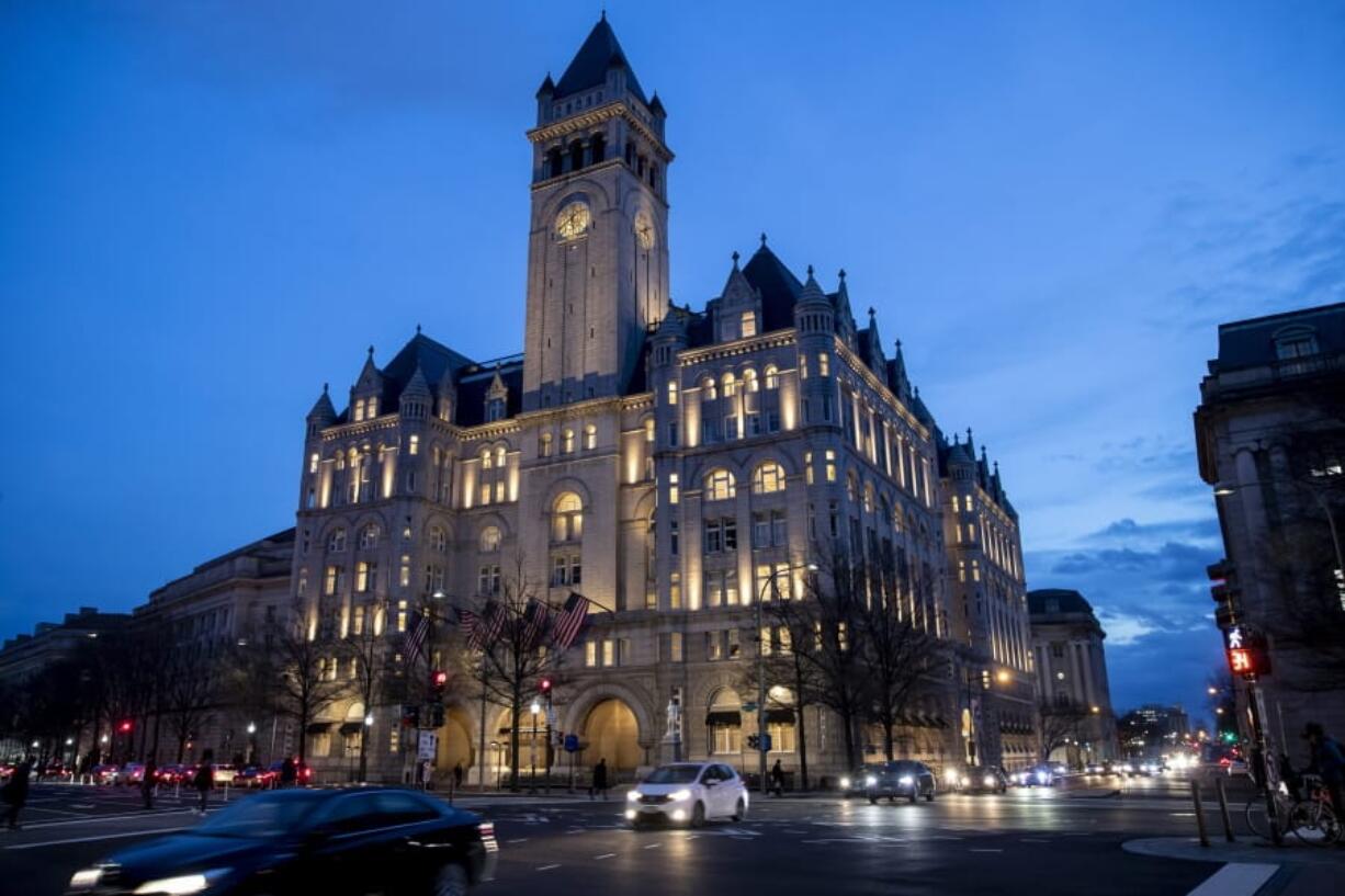 FILE - In this Jan. 23, 2019, file photo, the Trump International Hotel near sunset in Washington. The Justice Department is challenging a District of Columbia federal judge’s decision allowing a case accusing President Donald Trump of profiting off the presidency to go forward. Justice lawyers want an appeals court to take the case instead.