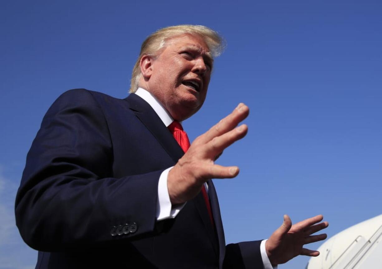 FILE - In a Sunday, July 7, 2019 file photo, President Donald Trump speaks at Morristown Municipal Airport in Morristown, N.J. resident Donald Trump’s New York state tax returns could be given to Congress under a new law in his home state. The measure was signed into law Monday, July 7, 2019 by Democratic Gov.