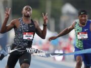 Christian Coleman celebrates in front of Michael Rodgers, right, as he wins the men’s 100-meter dash final at the U.S. Championships athletics meet, Friday, July 26, 2019, in Des Moines, Iowa.