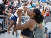 Allyson Felix holds her daughter Camryn after running the women’s 400-meter dash final at the U.S. Championships athletics meet, Saturday, July 27, 2019, in Des Moines, Iowa.