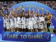 United States’ team celebrates with the trophy after winning the Women’s World Cup on July 7, 2019 in France.