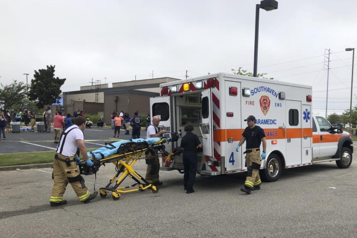 Medical staff stage outside a Walmart store, Tuesday, July 30, 2019, in Southaven, Miss. Officials say at least two people are dead and a police officer and a suspect were shot at the Walmart in the northern Mississippi city town, a suburb of Memphis, Tenn.